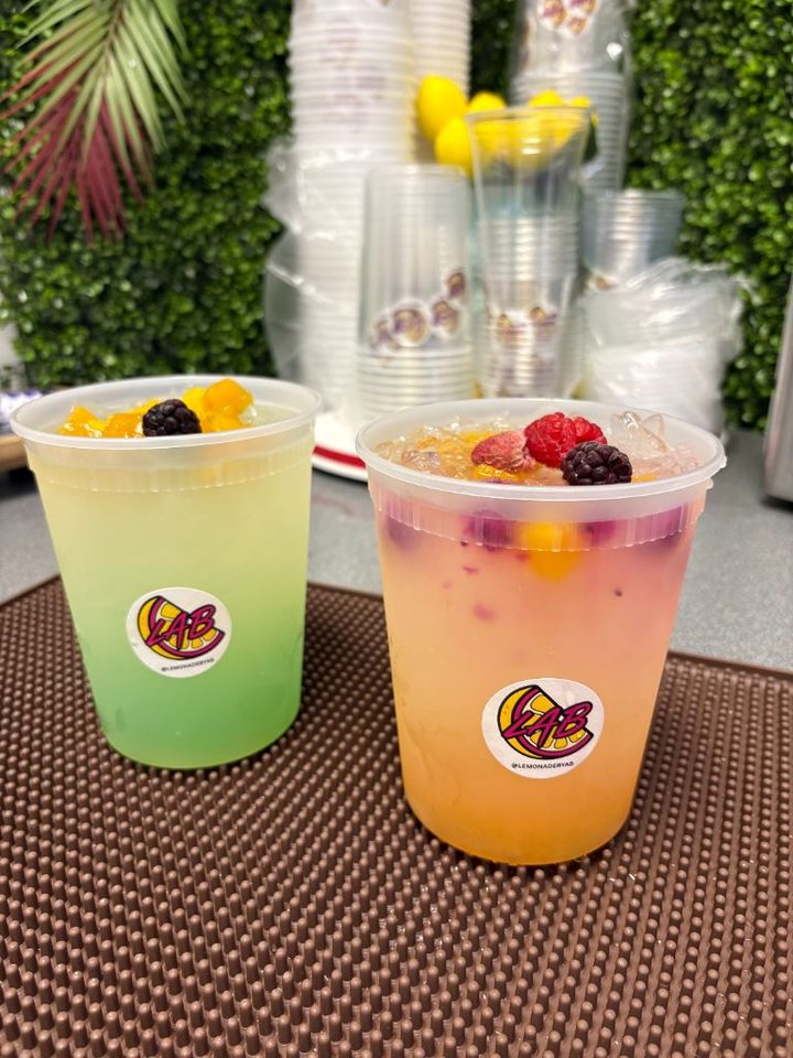 Two LAB lemonades topped with fresh fruit